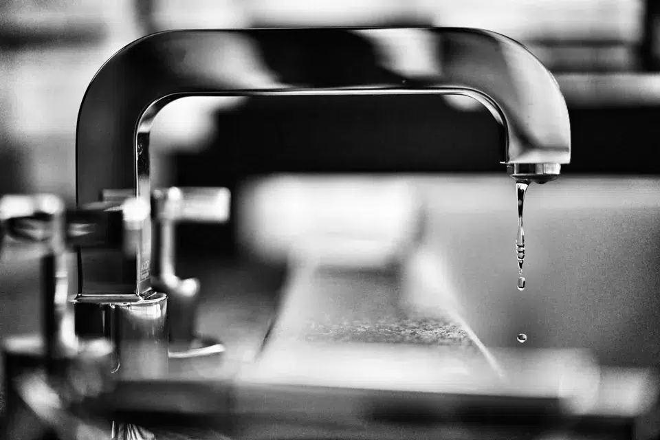a sink faucet leaking water