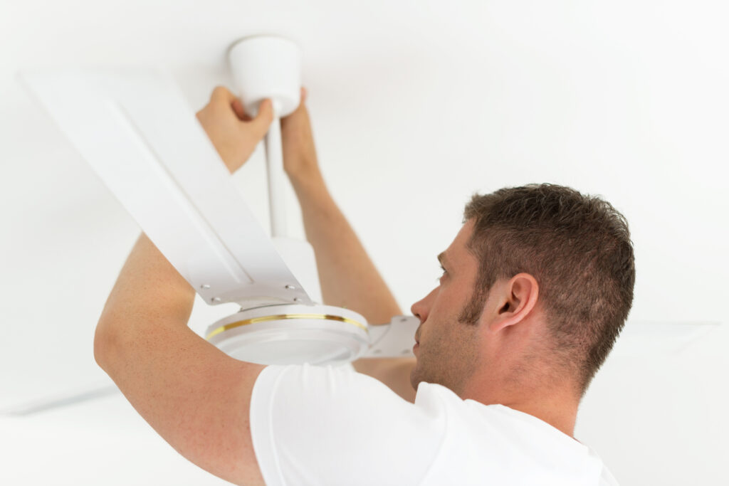 Technician installing a residential ceiling fan